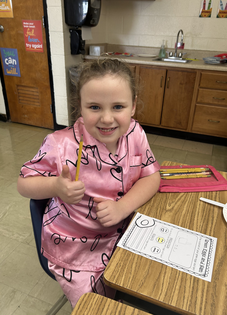 A student is giving the thumbs up sign. 