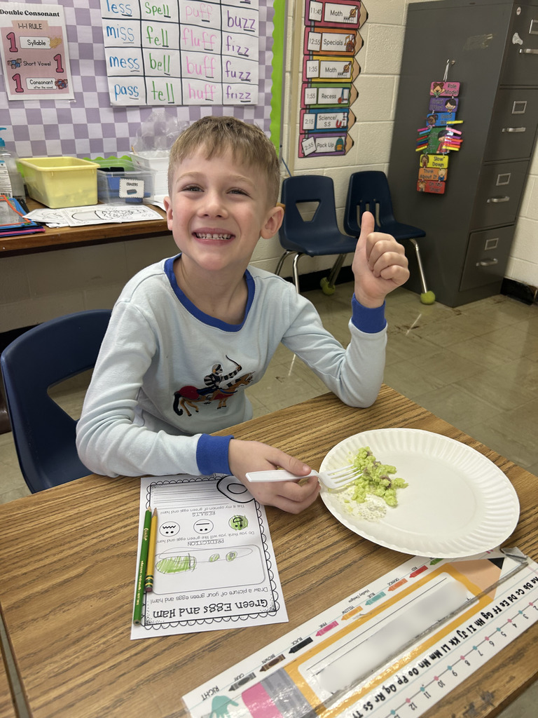 A student is giving the thumbs up sign. 