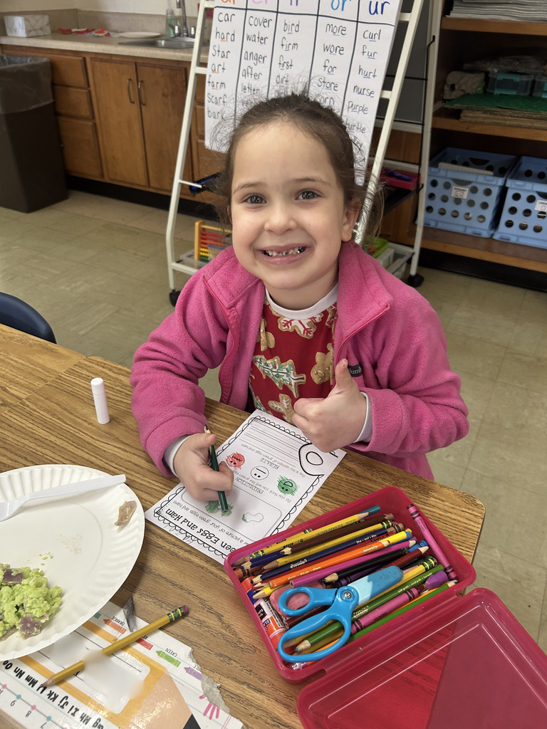 A student is giving the thumbs up sign. 