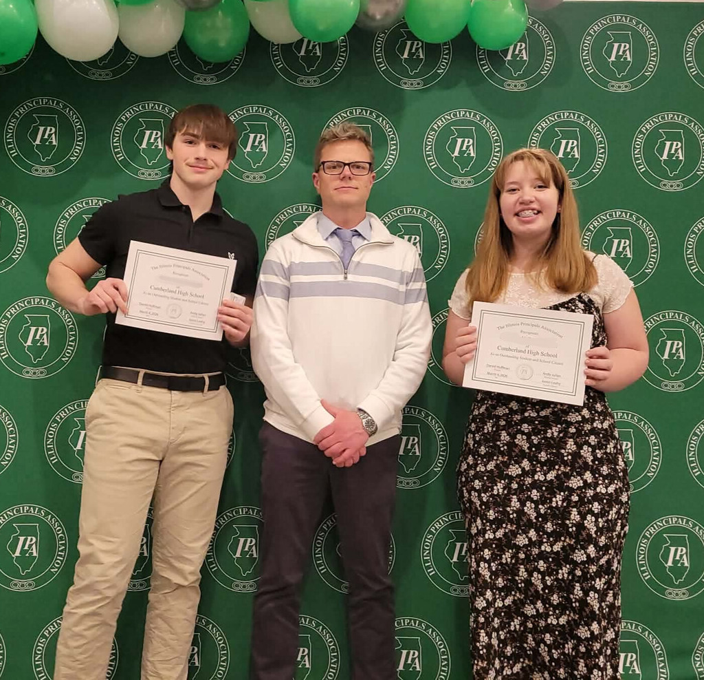 Pictured are two students and their principal. The students are holding their certificates. 