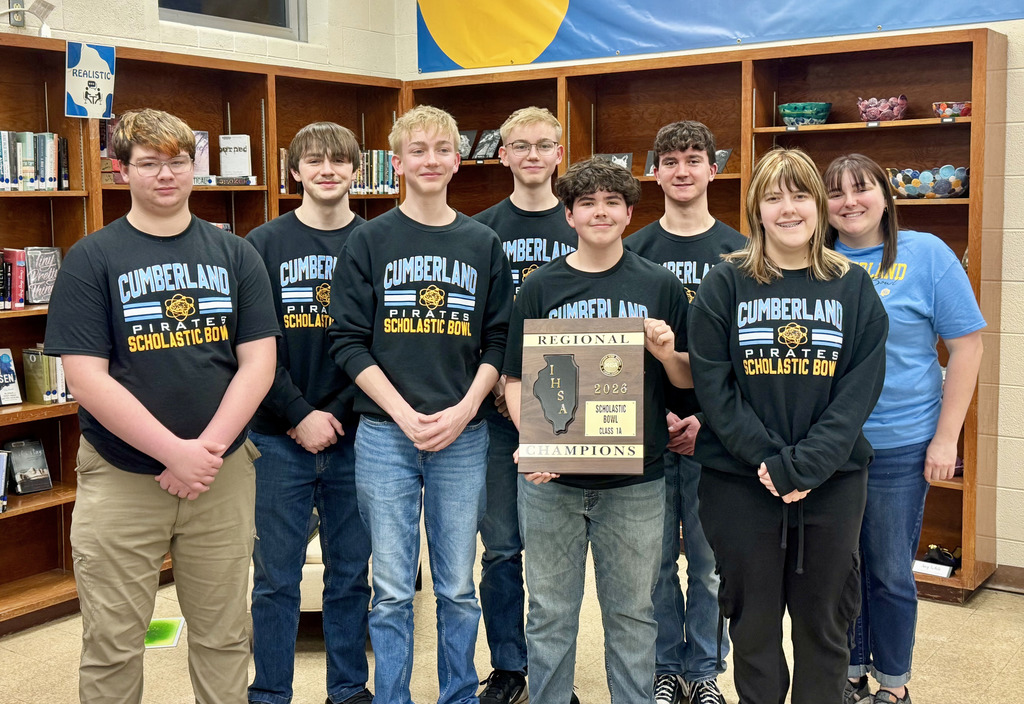 THe team of seven is standing together with the coach. The student in the center is holding the regional champion trophy. 