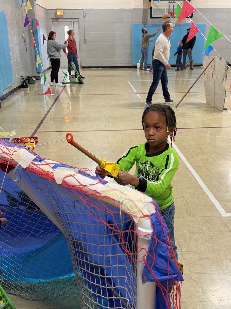 A student is fishing for a prize at the fish pond. 