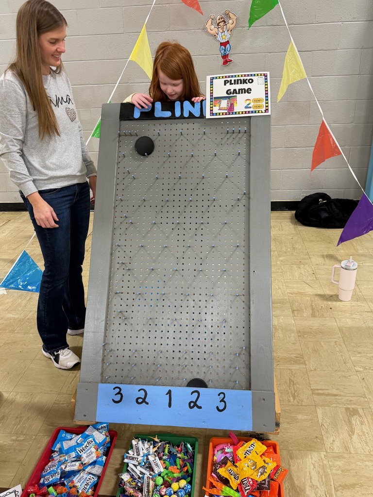 A student is dropping a tile down the plinko board. 