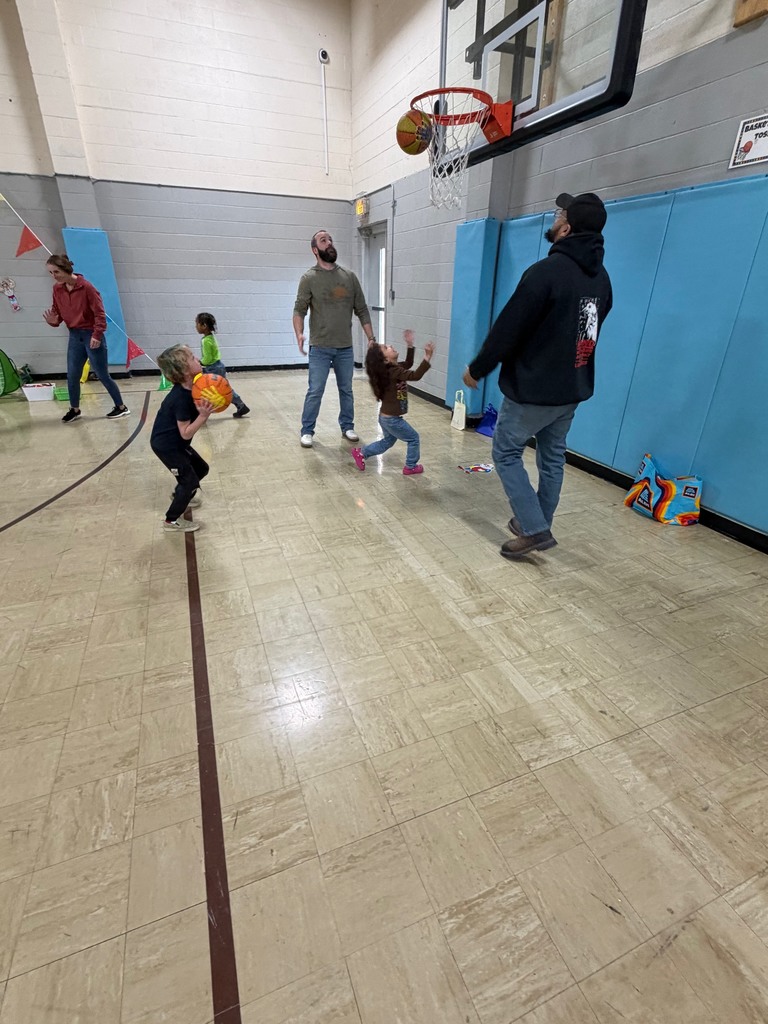 Three students are shooting baskets. 