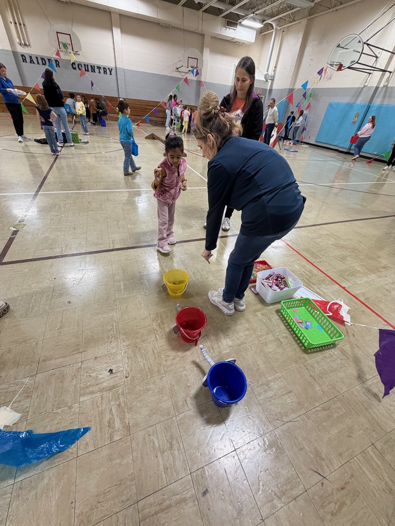 A student is throwing peanuts in buckets. 