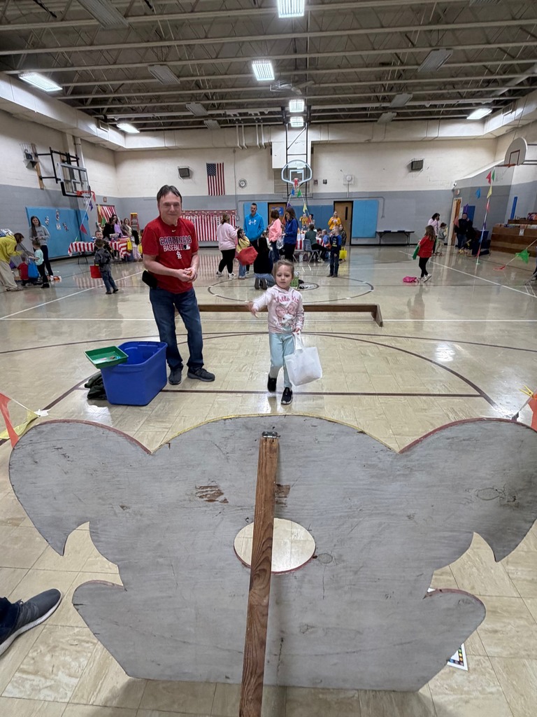 A student it throwing a beanbag at a clown. 