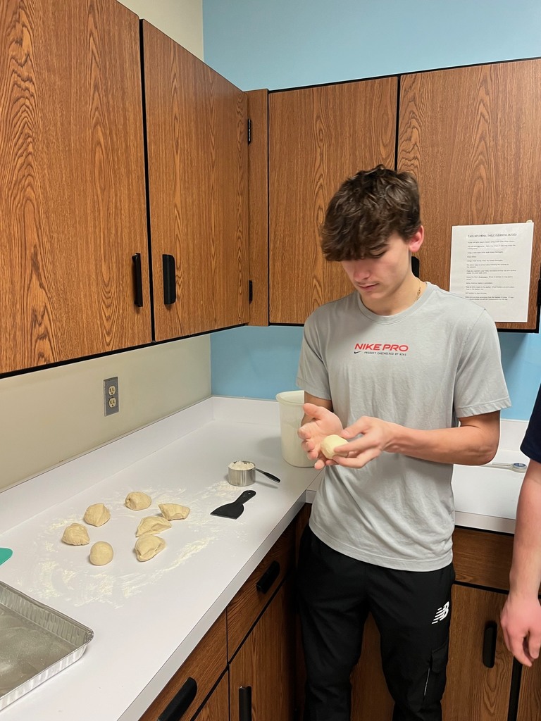 A student is shapping dough into balls. 