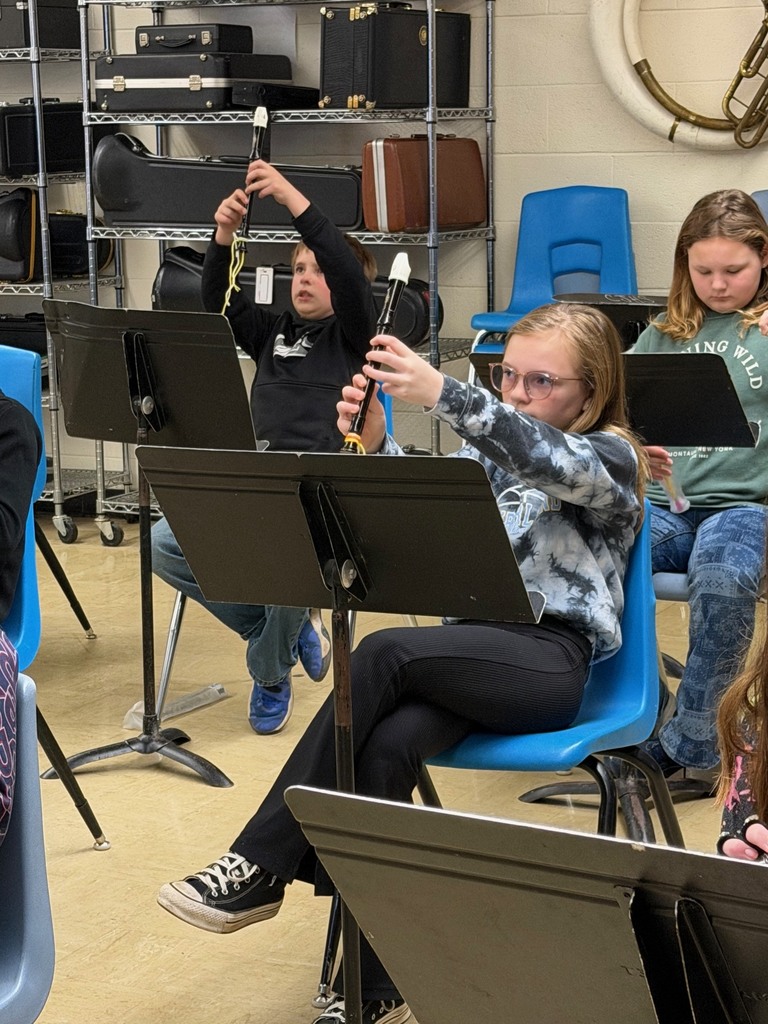 Students are holding up the recorder showing the finger placement for the new note.