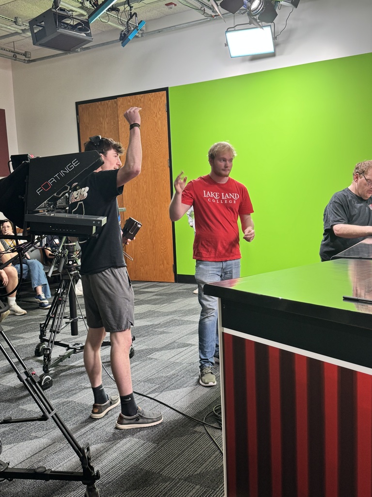 A student is directing the news broadcast. 