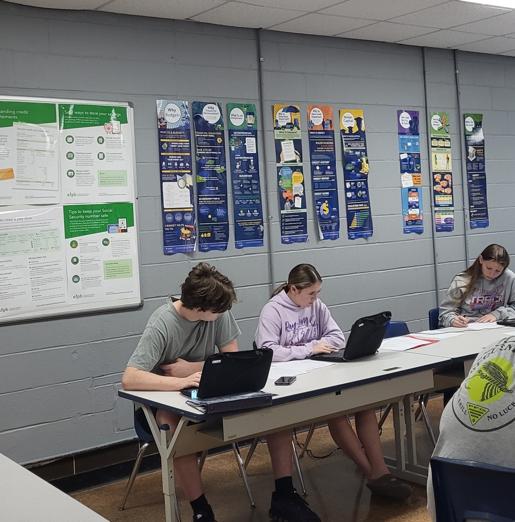 Two students are working on their Chromebooks.