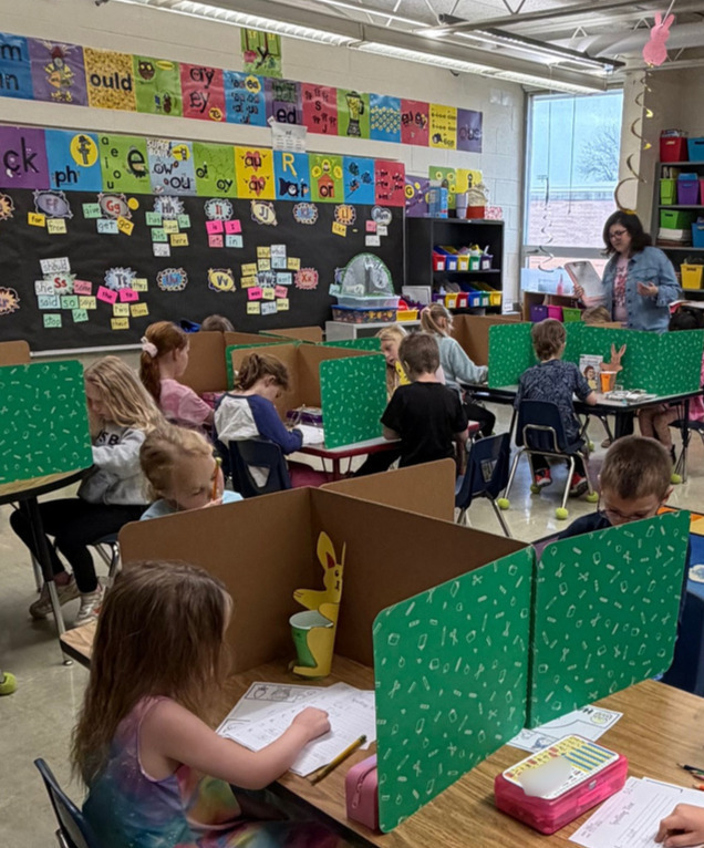 Students are taking a made up spelling test with their "new" teacher.