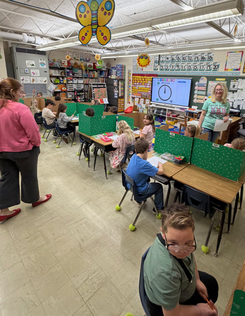 Students are taking a made up spelling test with their "new" teacher.