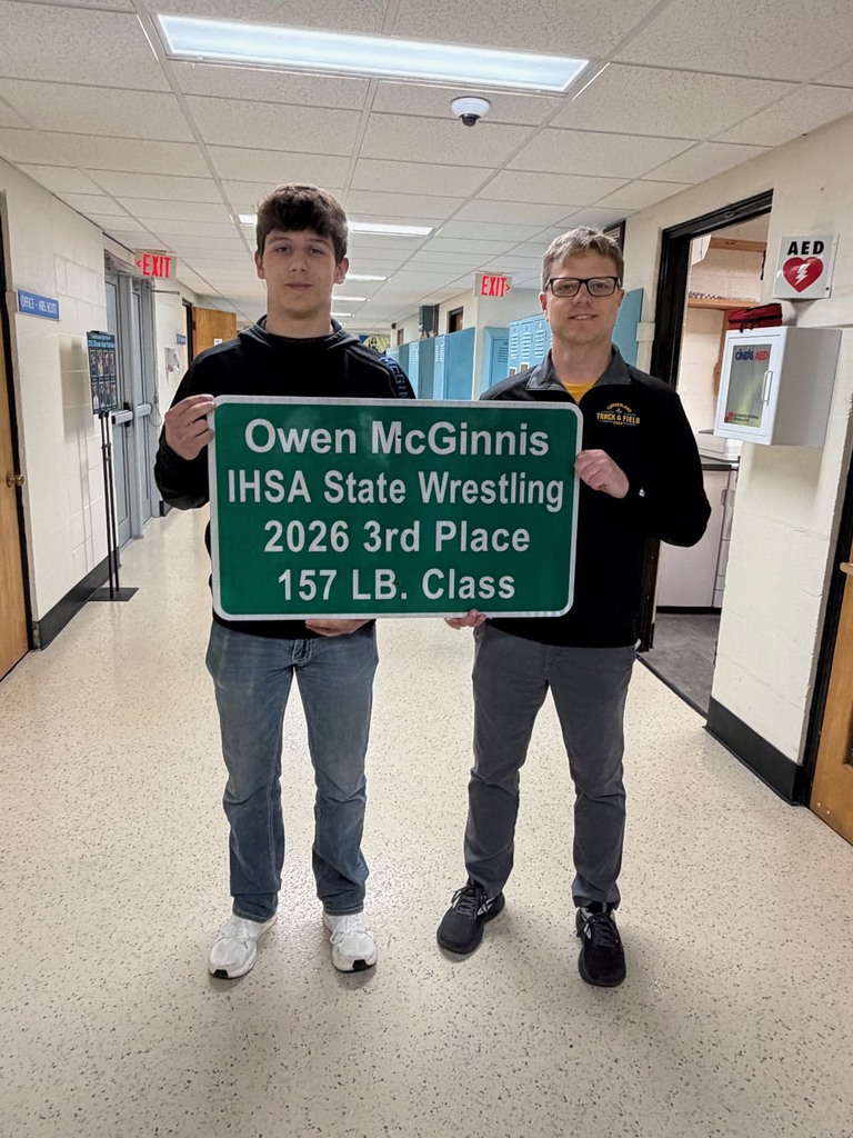 A student and principal are holding a sign that reads Owen McGinnis IHSA State Wrestling 2026 3rd Place 157 LB Class.