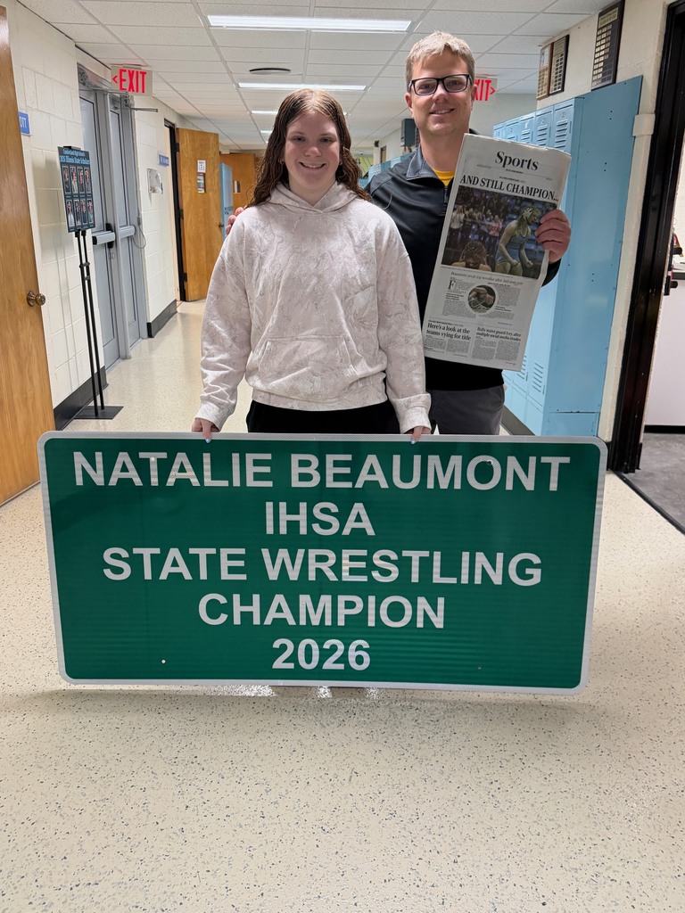 A student and the principal are holding the sign that reads Natalie Beaumont IHSA State Wrestling Champion 2026 and holding the newspaper.
