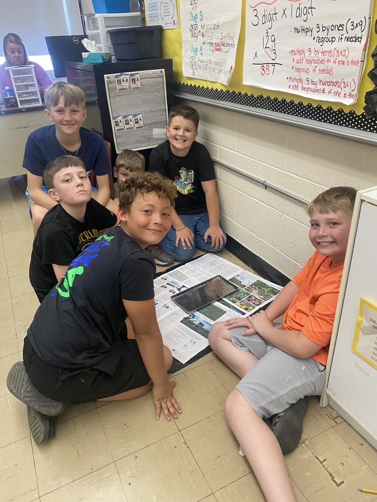 Five students are sifting though the soil to find worm cocoons.  