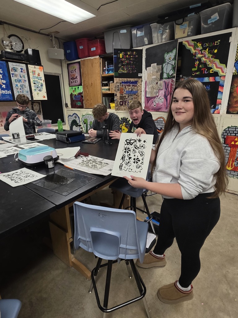 A student is holding up their example print.