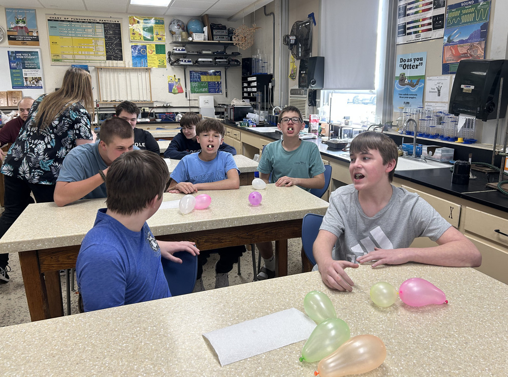 Students have a small piece of something in their mouths that makes it look like they are breathing steam.