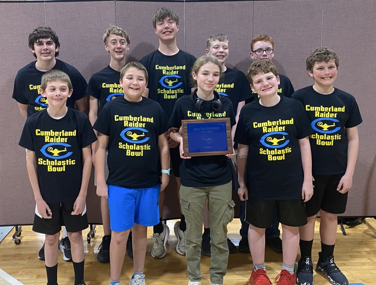 The team is standing together holding the NTC championship plaque  