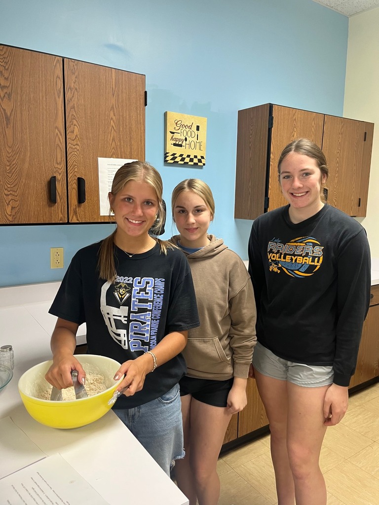 Three students are mixing the dough. 