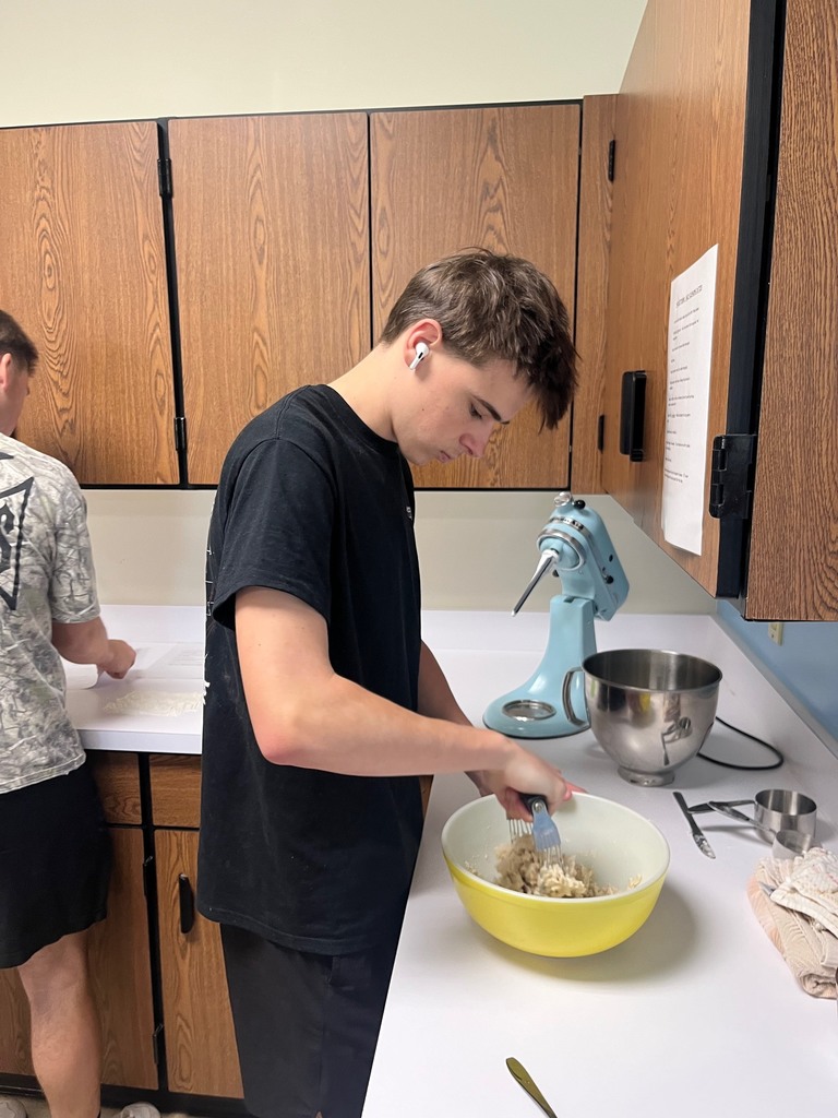 One student is mixing the doug.