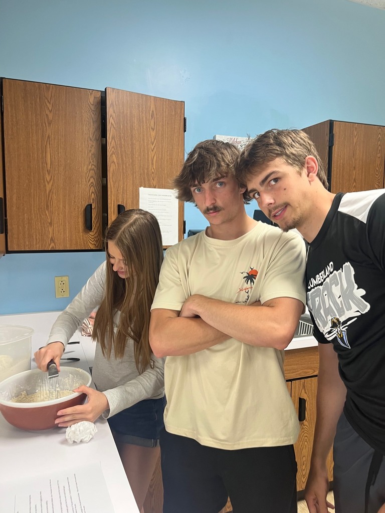 Three students are mixing the dough. 