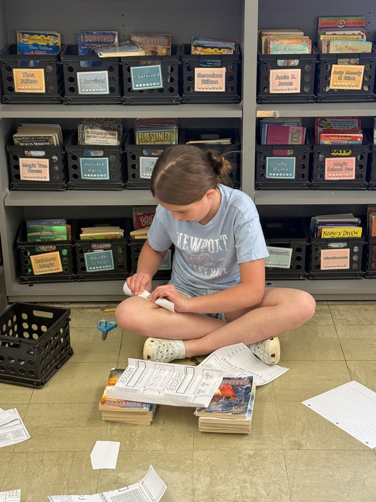 A student is folding paper to make the bridge. 