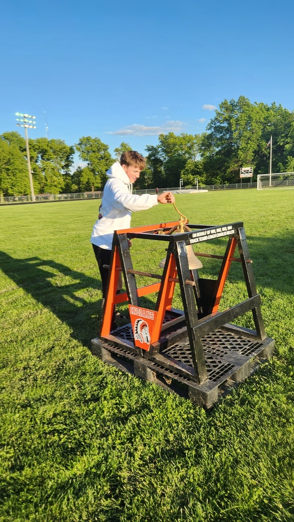 An athlete is ringing the bell. 