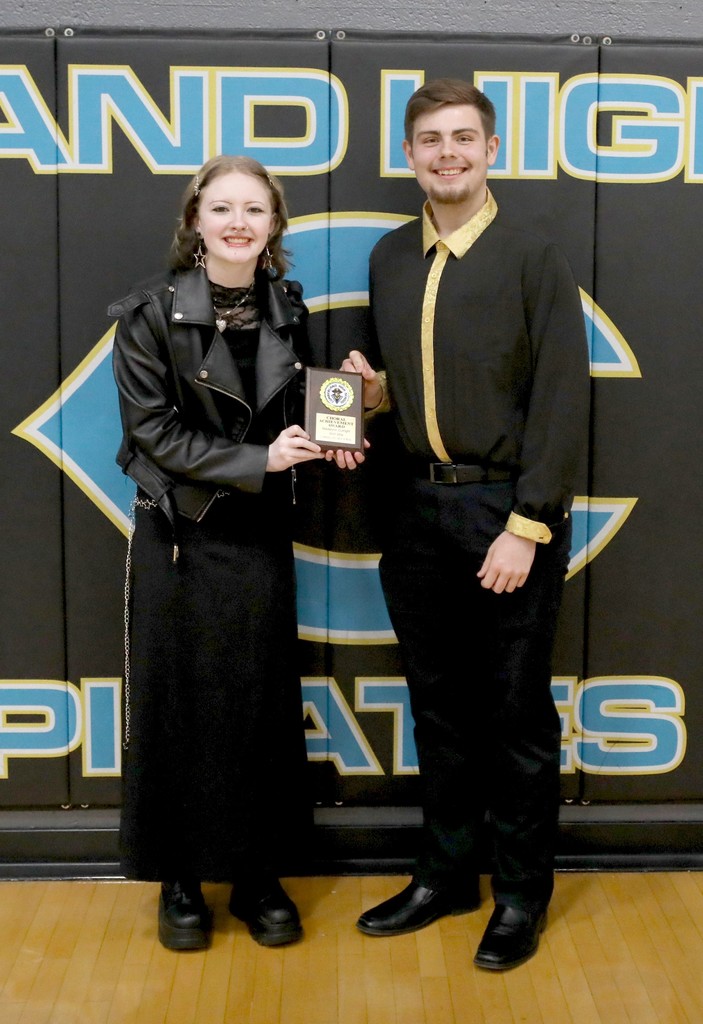 The two outstanding choir students are standing with their plaque. 