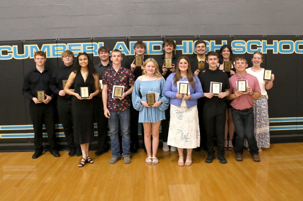 The band seniors are standing with thier plaques. 