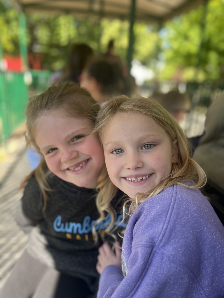 Two students are standing together. 