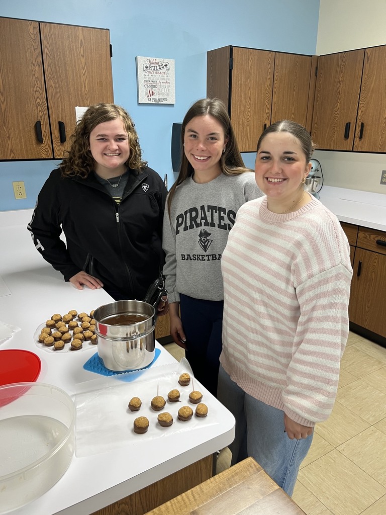 Three students are standing by their finished product. 
