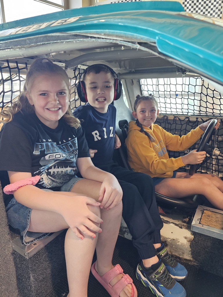 Three students are "Driving" a car. 