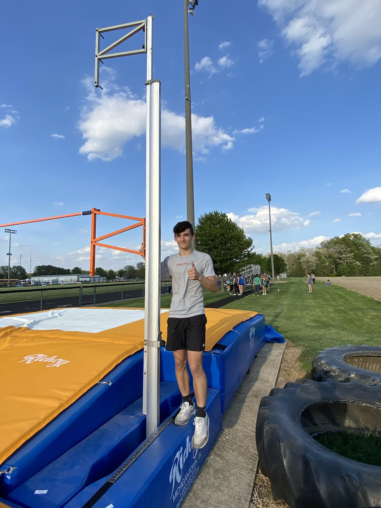 A Cumberland student is setting up the pole vault for a meet. 