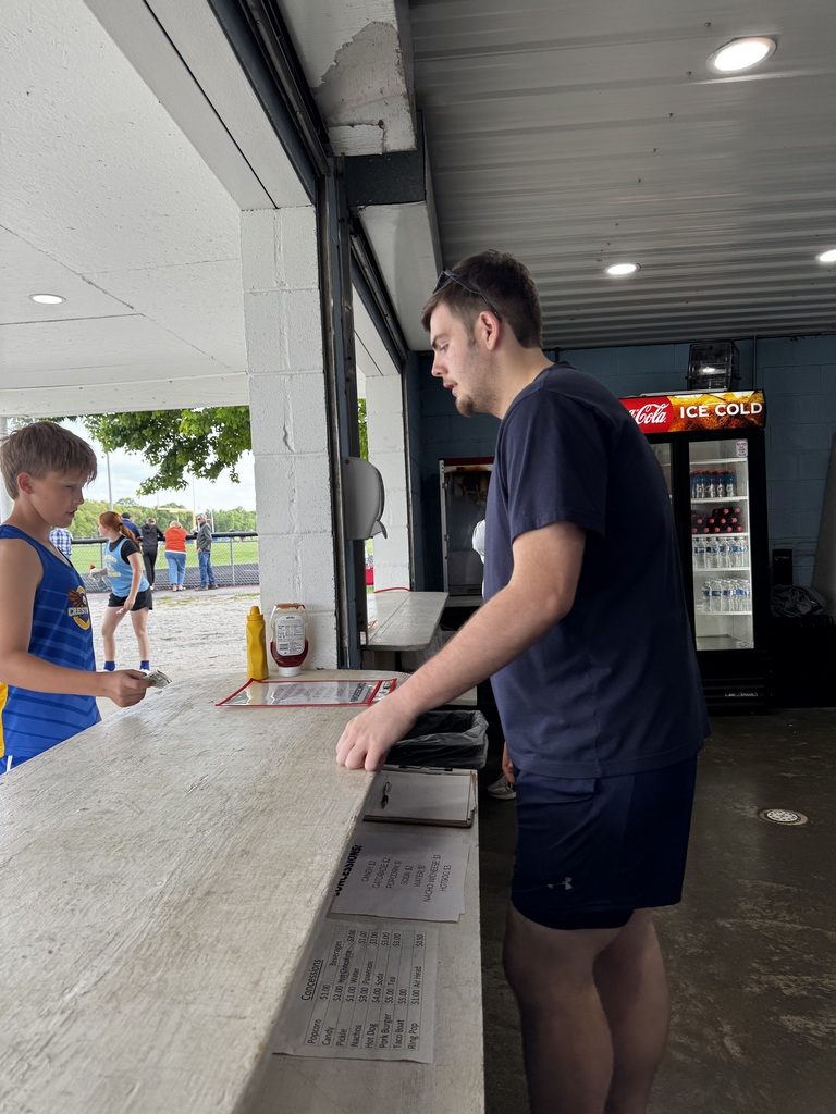 A Cumberland student is working at the track concession stand. 