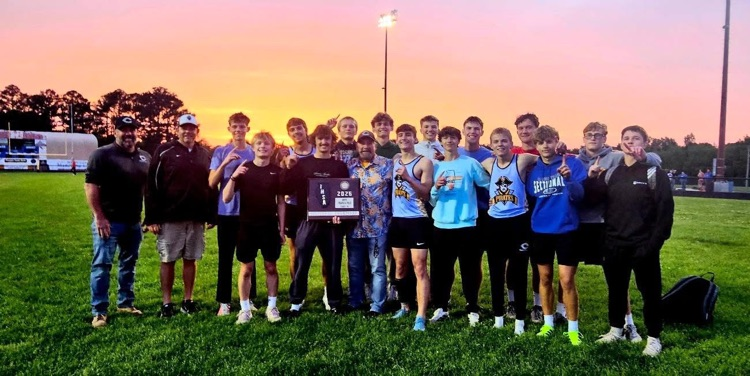 the team and coaches are pictured with the sectional trophy  