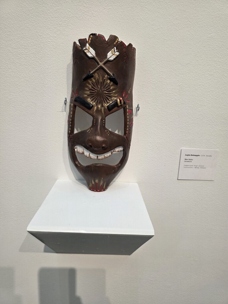 An artwork piece is pictured. It is a mask. 