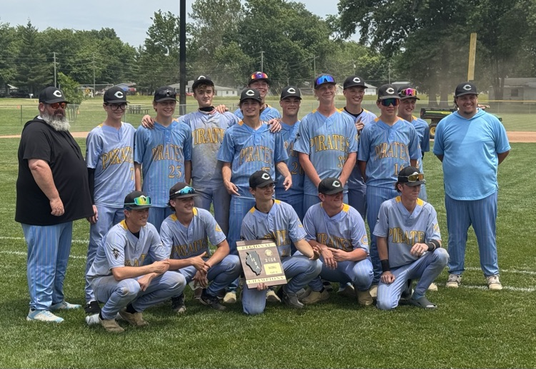 The team is in two rows flanked by the two coaches. The players in the center are holding the championship plaque  