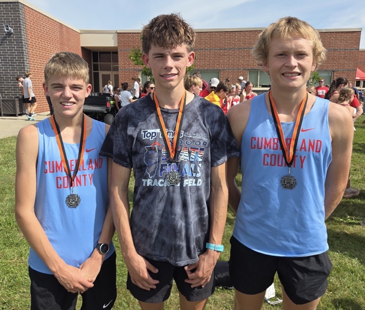 Pictured are the three medalists wearing their medals  