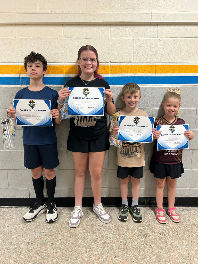 Pictured are the four Raiders of the Month. They are holding a certificate and their goodie bag.
