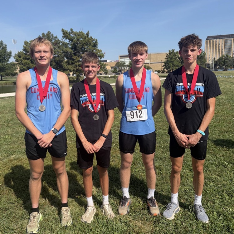 pictured are the four medalists wearing their medals  