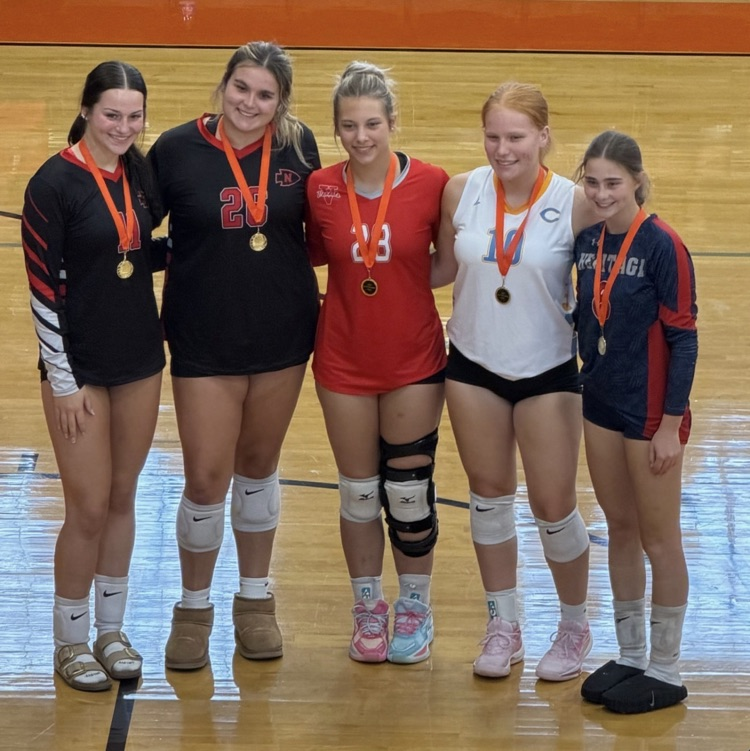 pictured are the four athletes who were selected for the all-tournament team. they are wearing their medals  