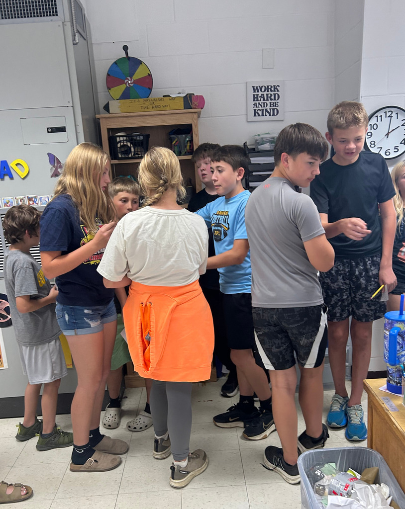 Students are gathered together sorting themselves into the order of events. 