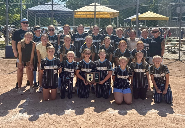 pictured is the team in 3 rows flanked by the coaches. they are holding the plaque  