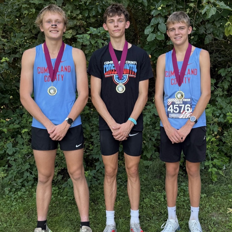 Pictured are the three medalists wearing their medals  