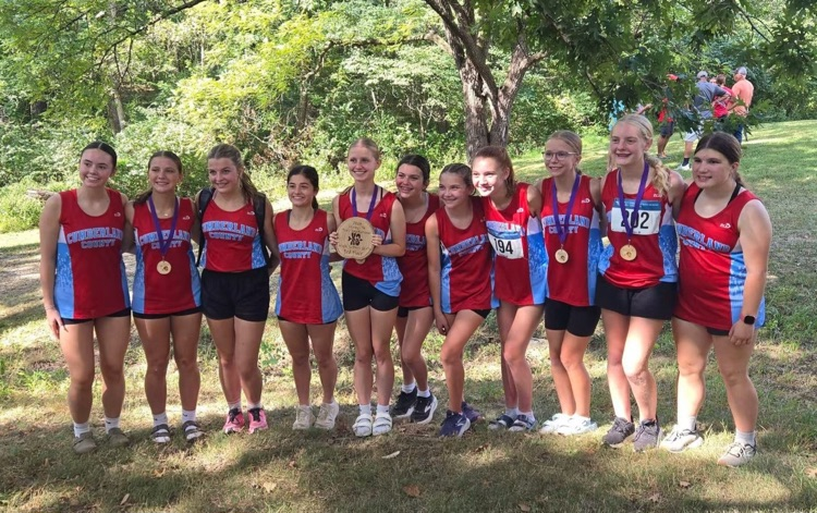 pictured is the team holding the third place plaque. the medalists are wearing the medals  