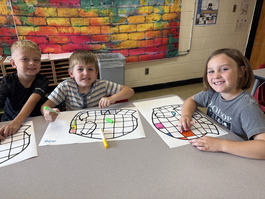 Three students are coloring a checkered elephant. 