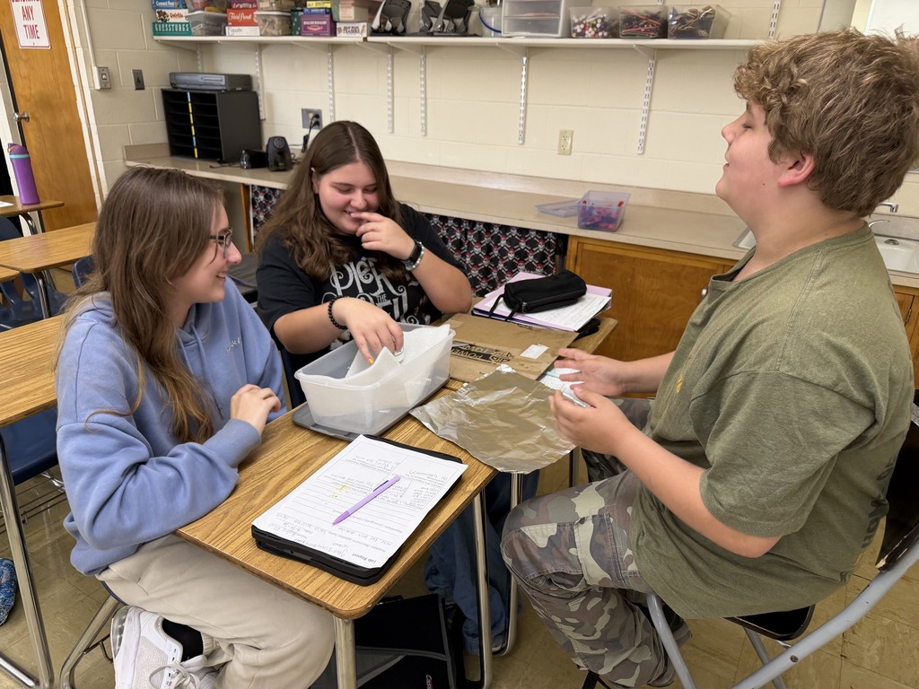 Three students are discussing their plan.