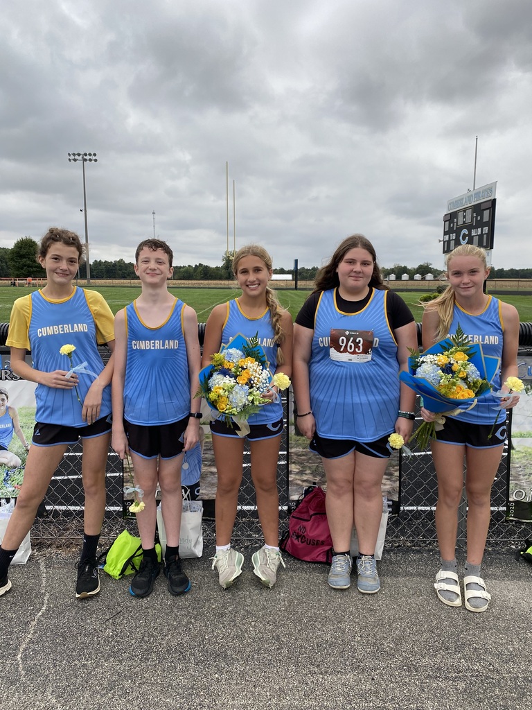 Pictured are the five 8th grade runners. They are in their blue uniforms and holding flowers.