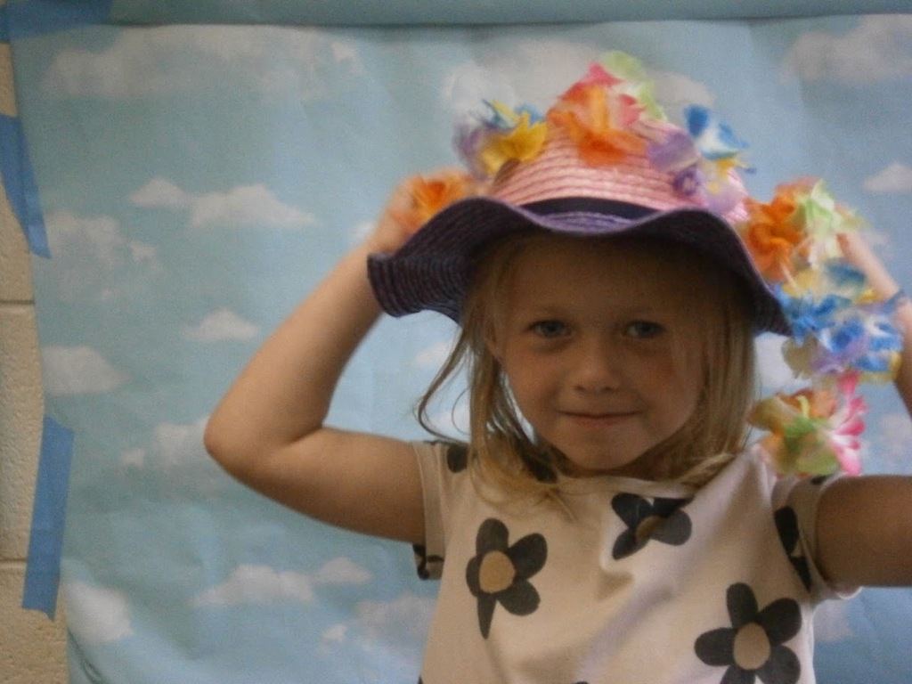 A student has a hat and a lei on.