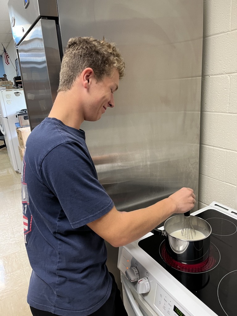 One student is stiring his cheese sauce. 
